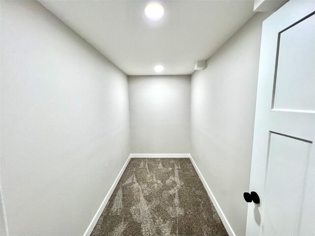 interior space with baseboards and carpet