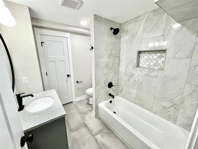 bathroom featuring vanity, washtub / shower combination, visible vents, baseboards, and toilet