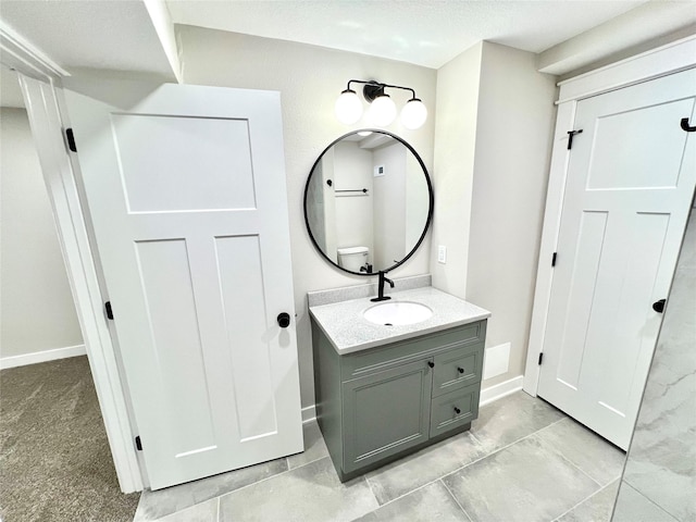 bathroom with vanity and baseboards