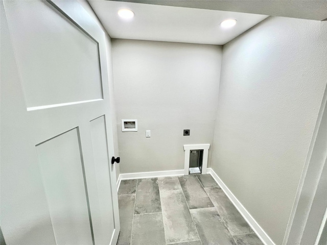 laundry area featuring baseboards, wood tiled floor, washer hookup, laundry area, and electric dryer hookup