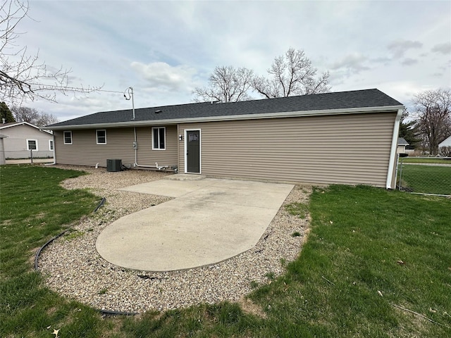 back of property featuring a lawn, central AC unit, a patio, and fence