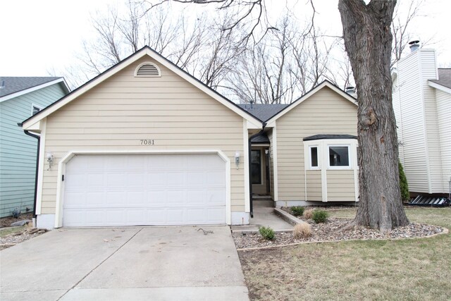 ranch-style house with an attached garage and concrete driveway
