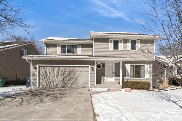 traditional-style home with a garage and driveway