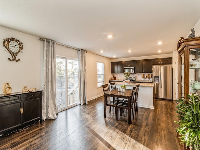 dining space featuring recessed lighting, baseboards, and dark wood-style flooring