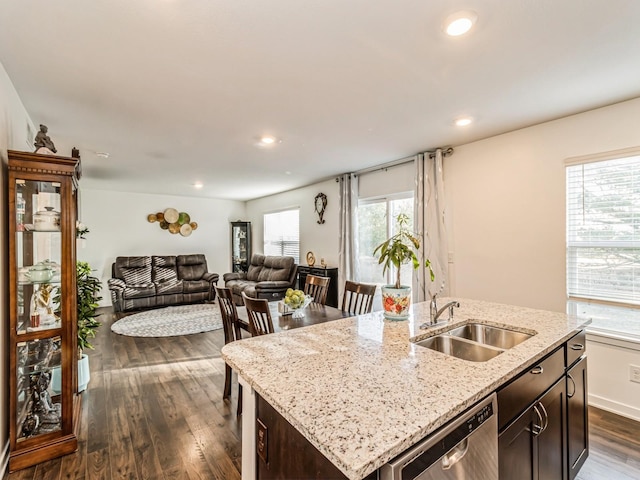 kitchen featuring a sink, dark wood-type flooring, dark brown cabinets, dishwasher, and open floor plan