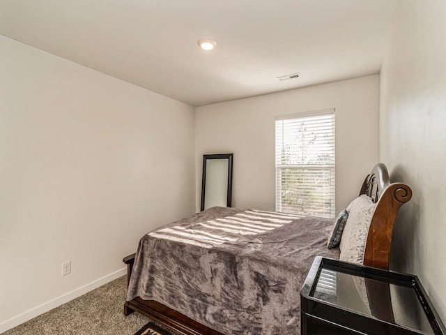 carpeted bedroom with visible vents and baseboards