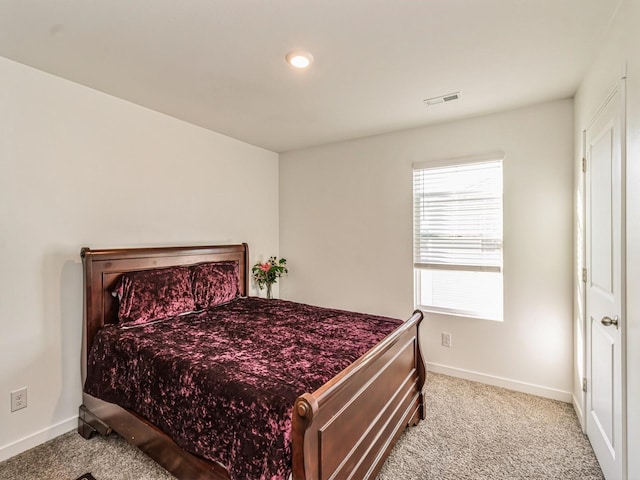 bedroom featuring visible vents, baseboards, and carpet