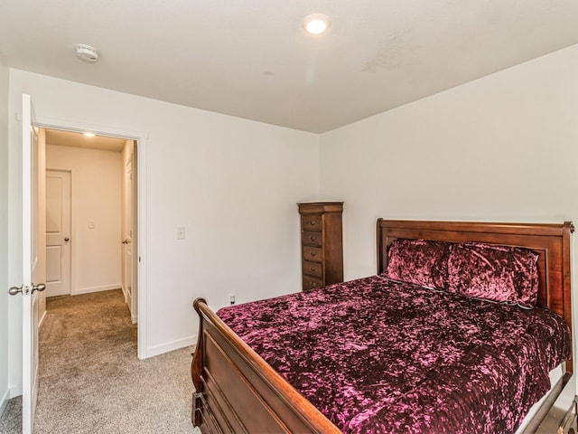 bedroom featuring baseboards and light carpet