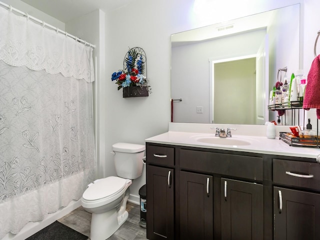 full bath featuring vanity, toilet, shower / bathtub combination with curtain, and visible vents