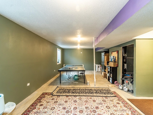 game room with a textured ceiling