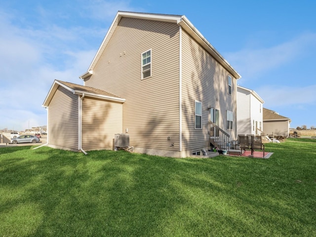 back of house with a patio, a yard, and central AC unit