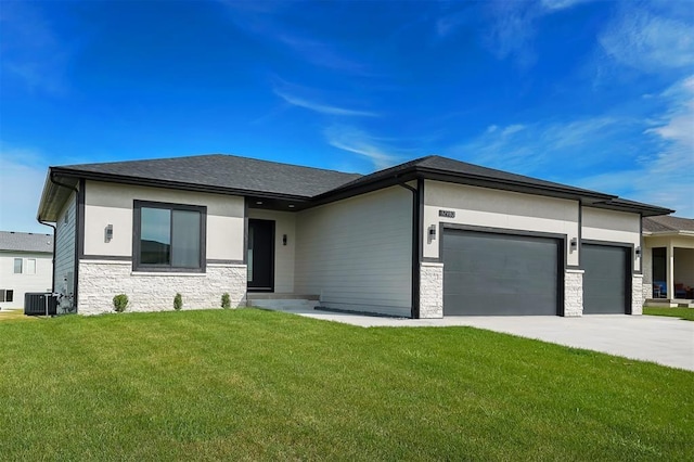 prairie-style home with driveway, a front lawn, stone siding, cooling unit, and a garage