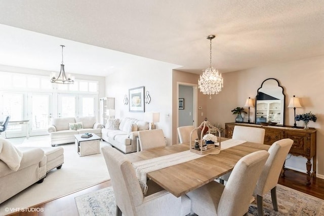 dining area with an inviting chandelier and wood finished floors