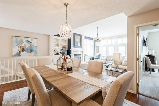 dining room with baseboards, an inviting chandelier, and dark wood-style flooring