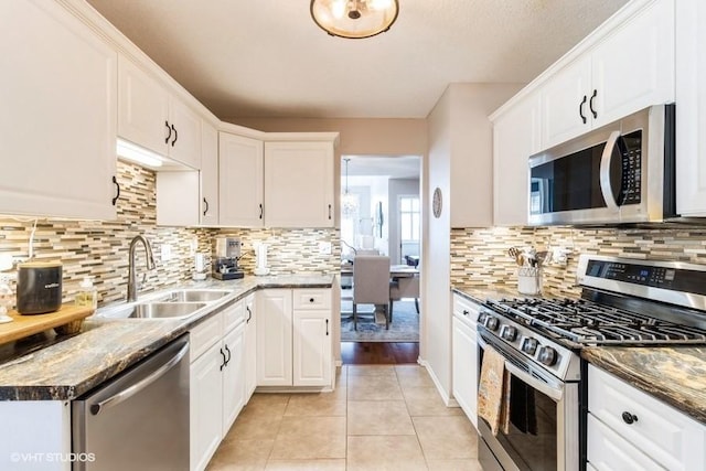 kitchen featuring a sink, white cabinets, light tile patterned floors, and stainless steel appliances