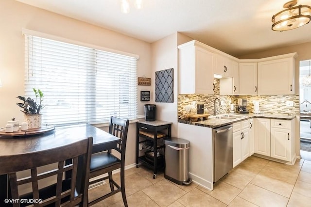 kitchen with dishwasher, white cabinetry, and a sink