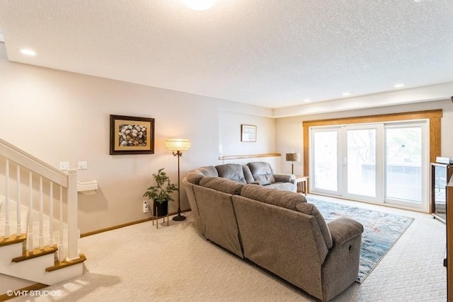 carpeted living room with stairway, recessed lighting, a textured ceiling, and baseboards