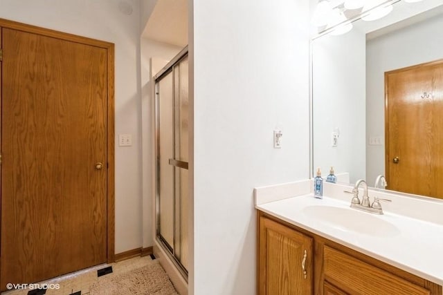 full bath with vanity and a shower stall