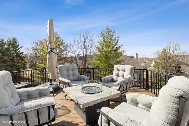 deck with an outdoor living space with a fire pit