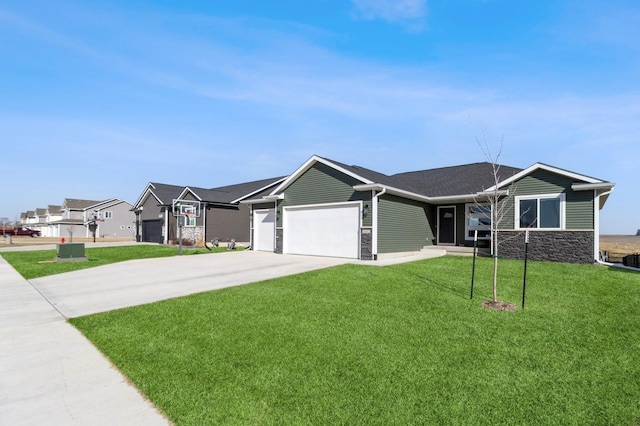 ranch-style house with an attached garage, stone siding, a front yard, and concrete driveway