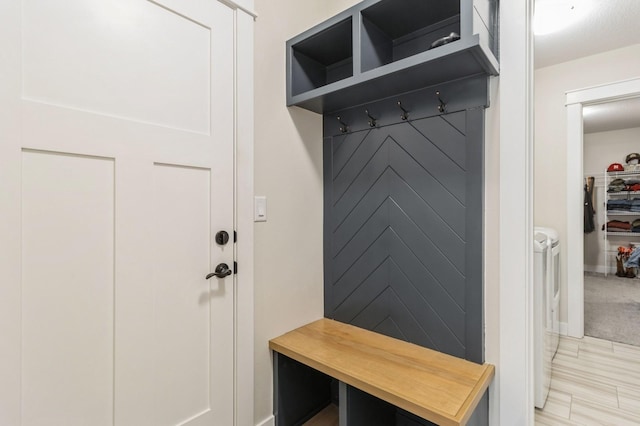 mudroom featuring independent washer and dryer and baseboards