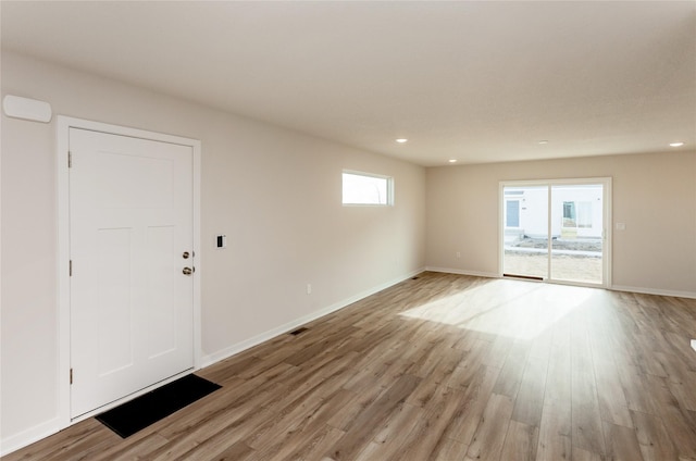 interior space with visible vents, recessed lighting, light wood-type flooring, and baseboards