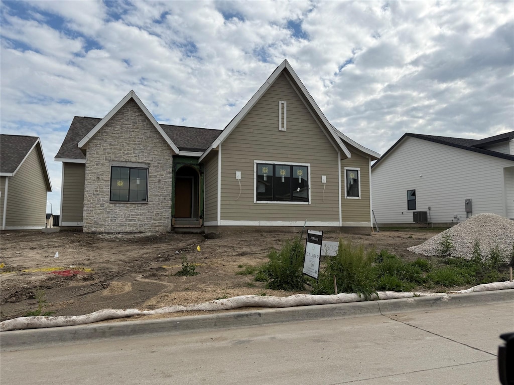 307 SW 17th St, Ankeny, IA 50023 - view of front of home featuring stone siding and central AC unit