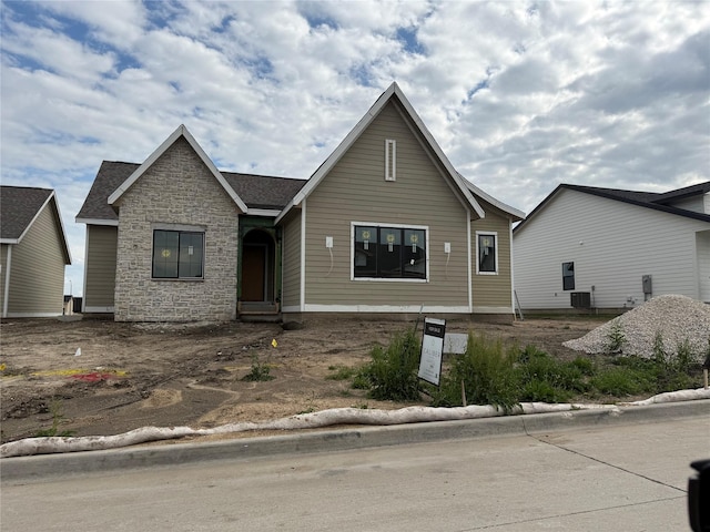 307 SW 17th St, Ankeny, IA 50023 - view of front of home featuring stone siding and central AC unit