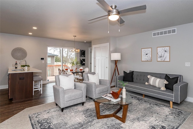 104 Mcpherson St, Boone, IA 50036 - living area with ceiling fan, a chandelier, dark wood-type flooring, and recessed lighting