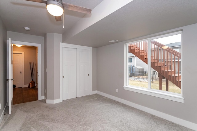 104 Mcpherson St, Boone, IA 50036 - unfurnished bedroom featuring carpet, a closet, and a ceiling fan