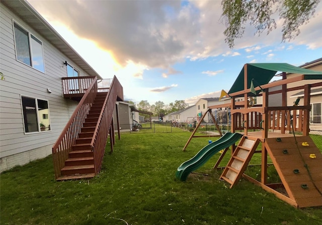 104 Mcpherson St, Boone, IA 50036 - view of jungle gym featuring a fenced backyard, stairs, and a wooden deck