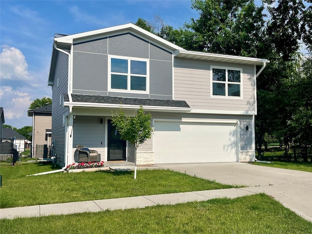 104 Mcpherson St, Boone, IA 50036 - view of front facade with an attached garage, concrete driveway, and a front yard