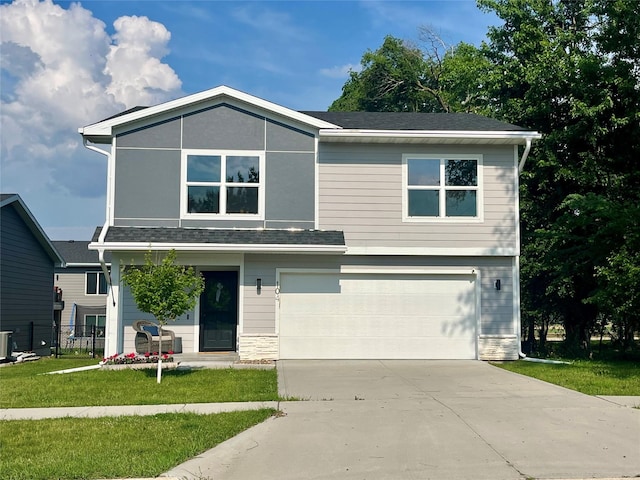 104 Mcpherson St, Boone, IA 50036 - view of front of property featuring a garage, driveway, and a front lawn