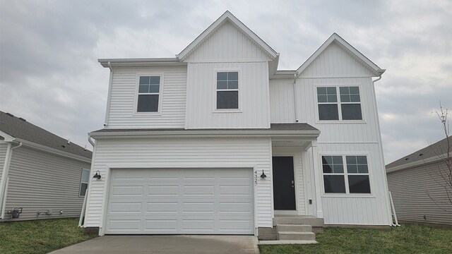 view of front of home featuring an attached garage, board and batten siding, and driveway