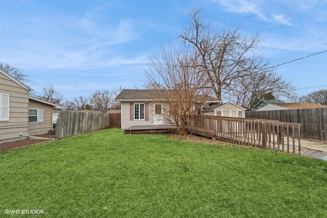 exterior space featuring a wooden deck and a fenced backyard