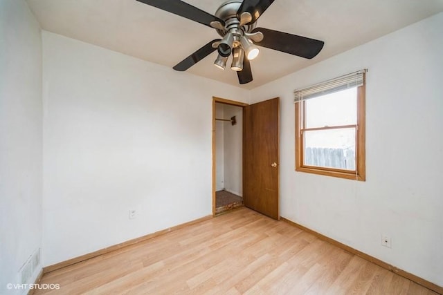 unfurnished room with visible vents, baseboards, light wood-style flooring, and a ceiling fan
