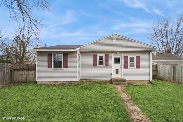 bungalow with a fenced backyard, a front yard, and entry steps
