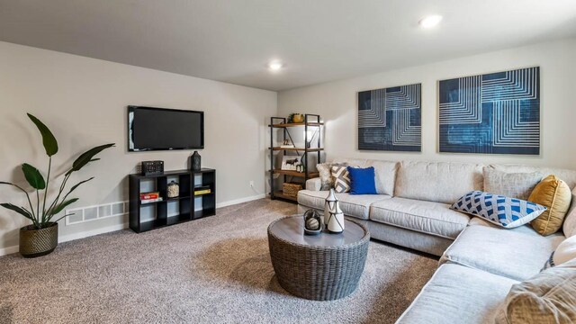 living room featuring carpet flooring, recessed lighting, visible vents, and baseboards