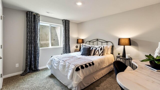 carpeted bedroom featuring visible vents and baseboards