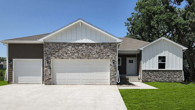 view of front of house with driveway, an attached garage, board and batten siding, and stone siding