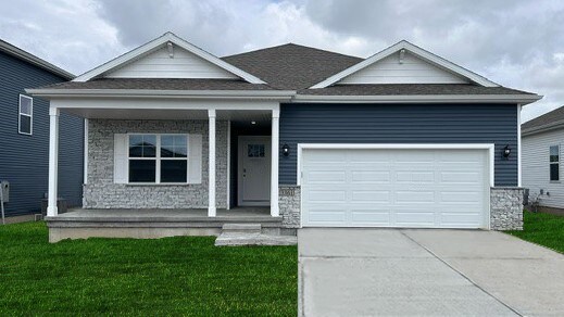 view of front of property featuring stone siding, a porch, driveway, and a garage