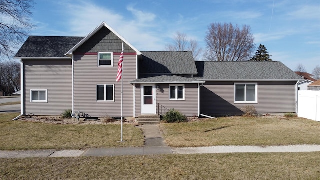 1408 Lincoln St, Gowrie, IA 50543 - view of front facade featuring entry steps, roof with shingles, a front yard, and fence