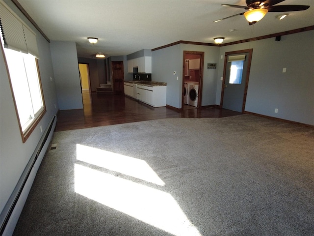1408 Lincoln St, Gowrie, IA 50543 - unfurnished living room with dark colored carpet, a sink, baseboard heating, a ceiling fan, and washer and dryer