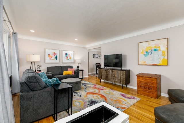 living room featuring recessed lighting, wood finished floors, and baseboards