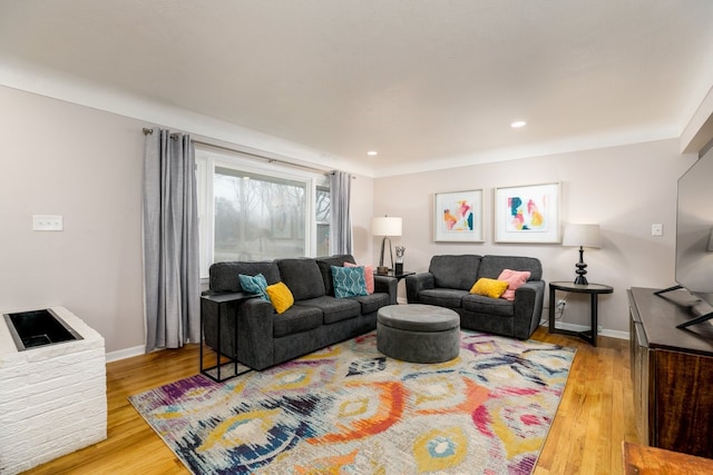 living area with recessed lighting, baseboards, and wood finished floors