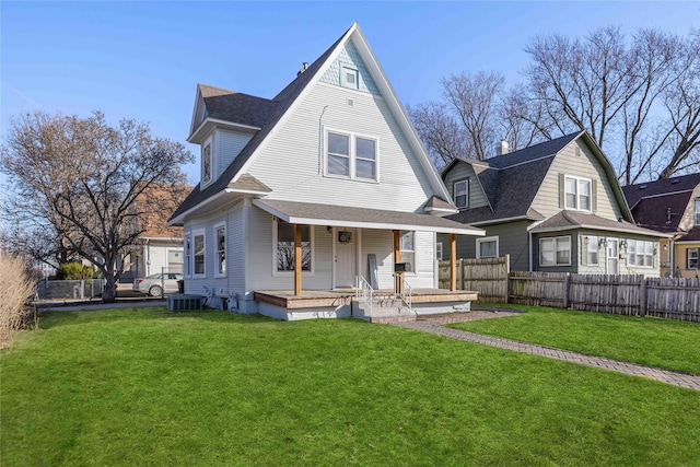 1702 Logan Ave, Des Moines, IA 50316 - view of front of house with roof with shingles, a front lawn, a fenced backyard, cooling unit, and covered porch