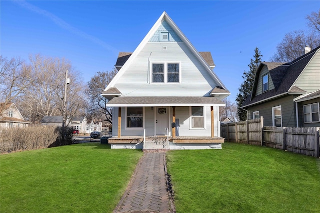 1702 Logan Ave, Des Moines, IA 50316 - view of front of house with a porch, roof with shingles, fence, and a front yard