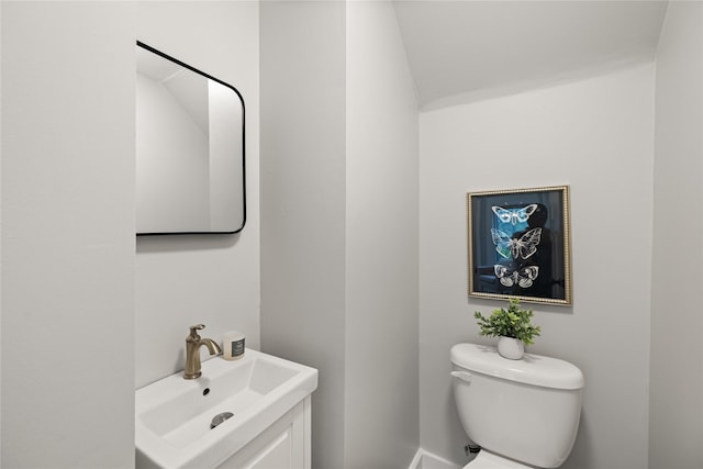 1702 Logan Ave, Des Moines, IA 50316 - bathroom featuring vanity, baseboards, and toilet