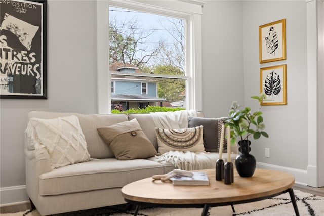 1702 Logan Ave, Des Moines, IA 50316 - living area featuring baseboards, wood finished floors, and a healthy amount of sunlight