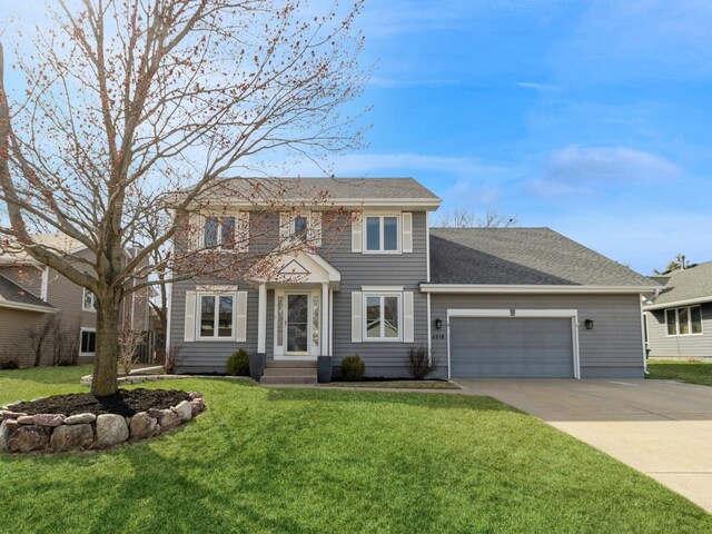 view of front of property featuring a front yard, a garage, driveway, and roof with shingles